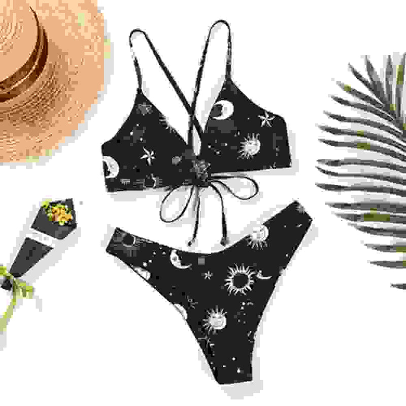 Black bikini set with white celestial print and tie front. Trendy padded biquini bathers for women’s beachwear.