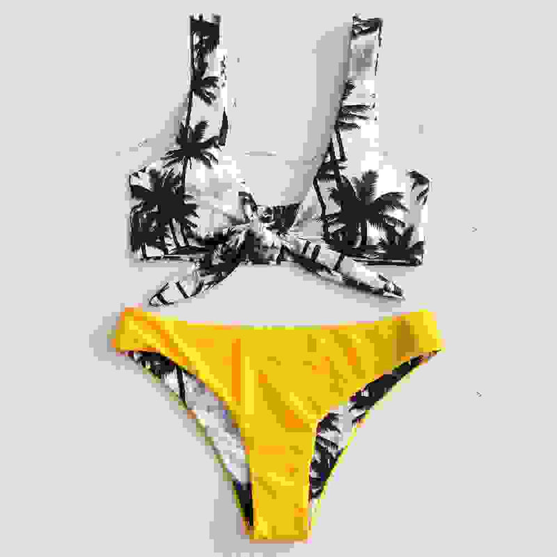 Palm tree print bikini top with yellow padded bikini bottom. Trendy bandage bathing suit for women’s summer fashion.