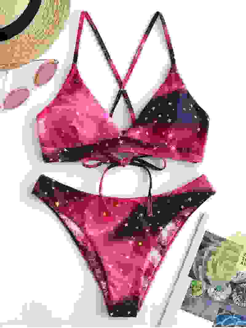 Pink galaxy print padded bikini set with criss-cross back. Trendy bandage bathing suit for women’s swimwear collection.