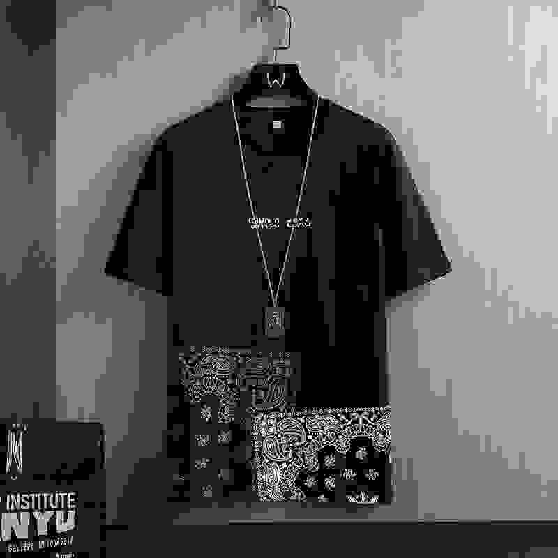 Men's T-Shirts - Geometric Print | Short Sleeve, Round Neck in black with white paisley block print and necklace accessory, youth streetwear style.